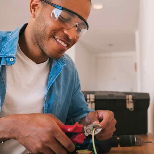 latin-man-fixing-electricity-problem-at-home-982TKSQ.jpg